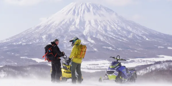Two riders looking out at Mt Yotei